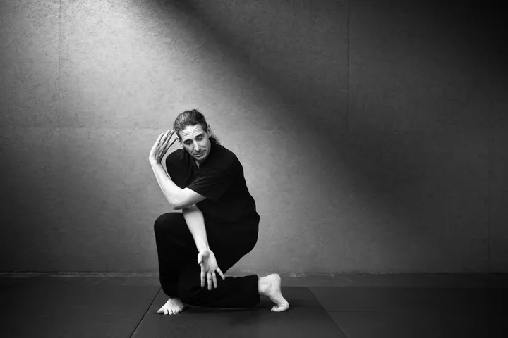 Julien Zeitoun en posture basse de Tai-Ji, dans le dojo.